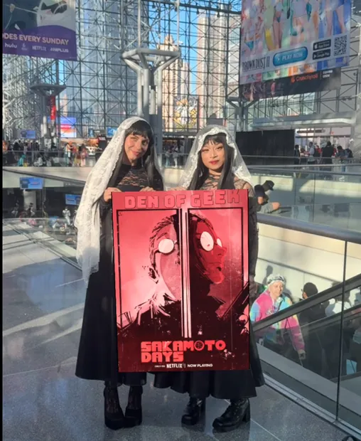 Fans holding the Den of Geek Sakamoto Days activated poster at Anime NYC