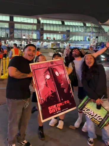 Fans outside the convention with the activated poster